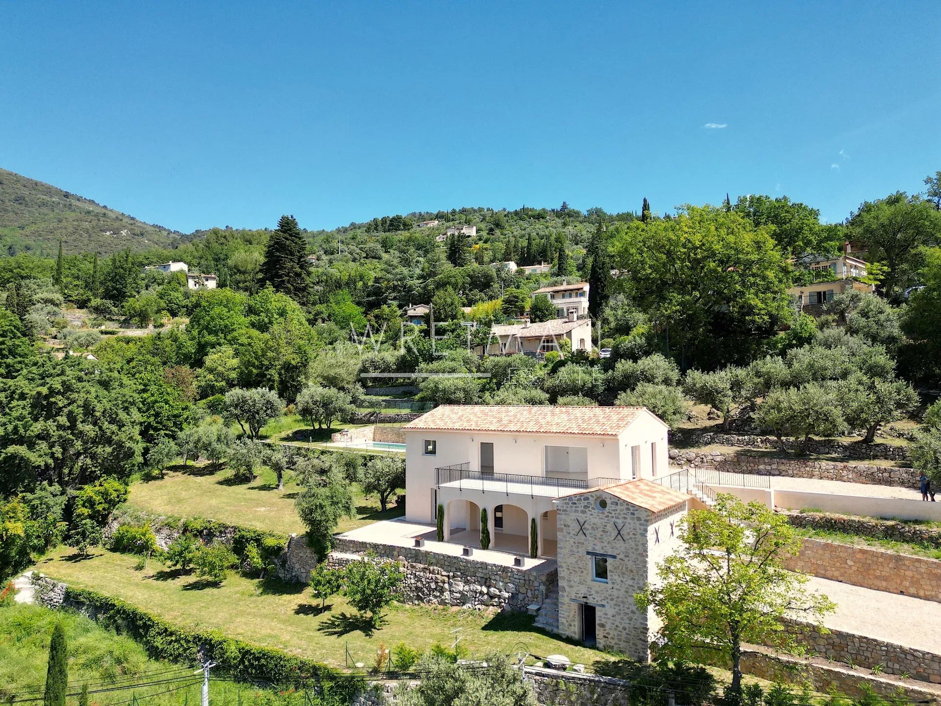 The villa and its stone annexe set in terraced olive groves